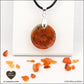 Pendentif Cornaline rond M.1 en orgonite laiton